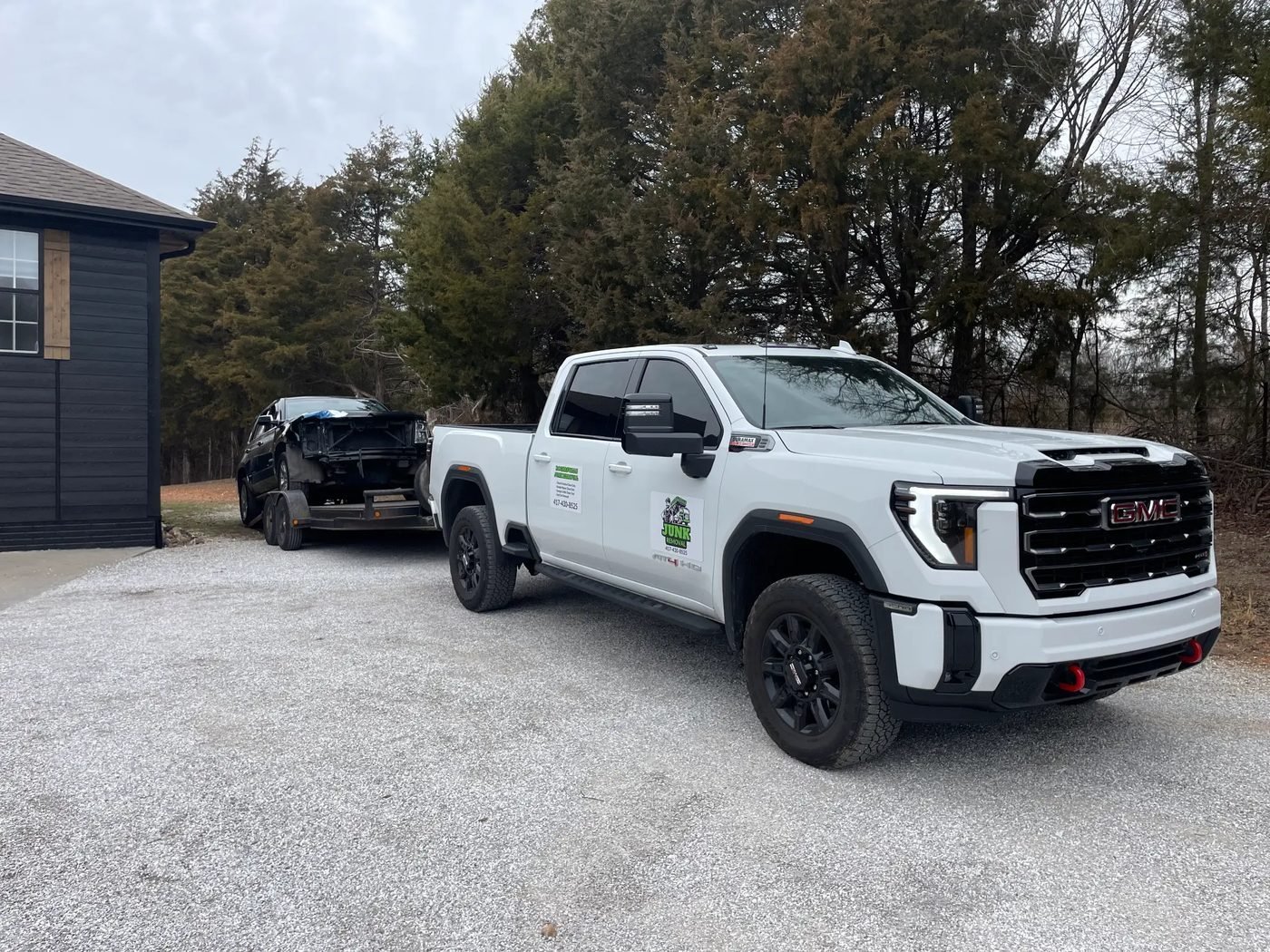 Rogersville Junk Removal truck hauling a junk car — professional junk car removal in Rogersville MO